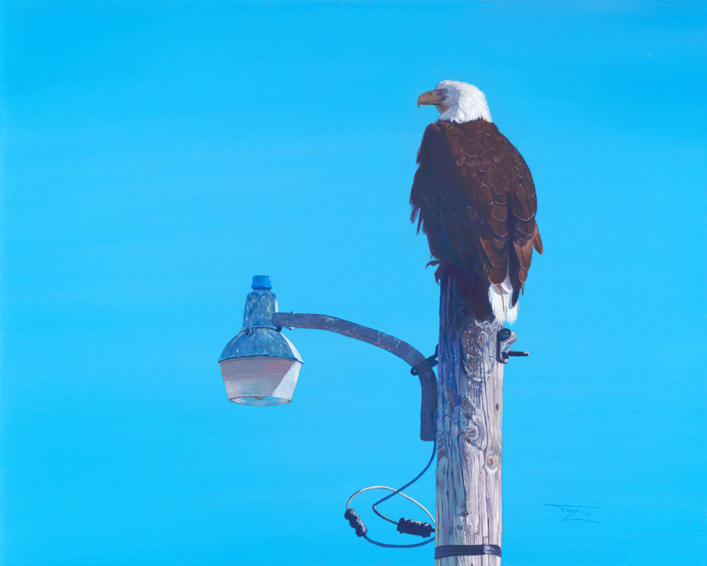 A painting of a bald eagle perched on a paint pole